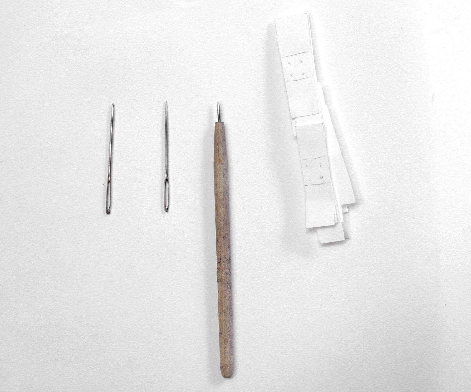 Etching needle, darning needle, paper abstractions of band-aids