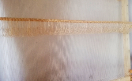 Warped tapestry loom with heddles.